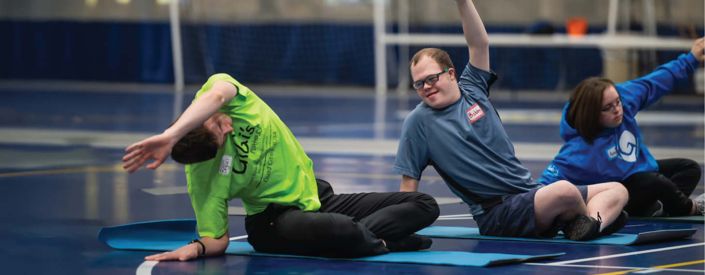 Person doing yoga in group.